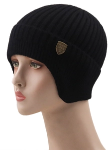 Black ribbed knit winter beanie with earflaps and golden shield emblem on a mannequin