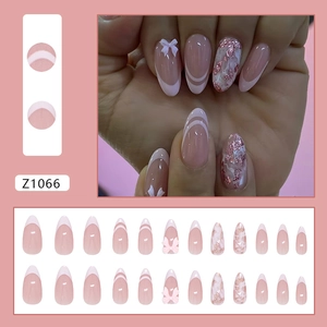 Pink French style press-on nail kit with 3D bows and shimmering ombre glitter patterns