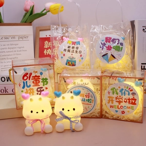 Detail of cartoon night light in gift box with decorative stickers and shredded paper