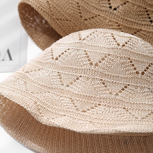 Close-up of intricate hollow knit texture on a lightweight summer straw bucket hat