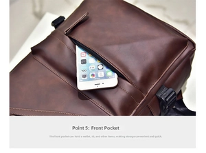 Macro detail of dark brown leather backpack front zipper pocket showing phone storage