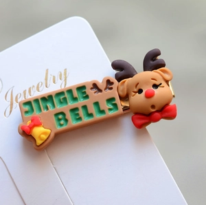Close-up of reindeer hair clip with Jingle Bells text and red bow on display card