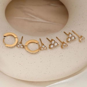 Gold stainless steel jewelry set with clover stud earrings and huggie hoops with zircon