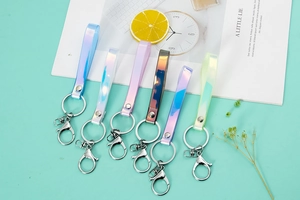 Detailed view of colorful iridescent PVC wristlet keychains with silver metal hardware