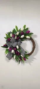 Detailed view of handmade tulip wreath with a gingham bow on a natural rattan base