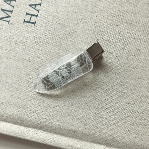 Elegant lace print hair clip with silver metal base shown from a 45-degree angle view