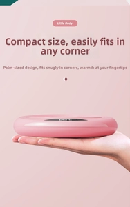 Handheld view of pink intelligent mug warmer with digital LED display showing 88°C