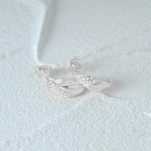 Detailed macro view of 925 silver C-shaped stud earrings with pavé set zirconia crystals