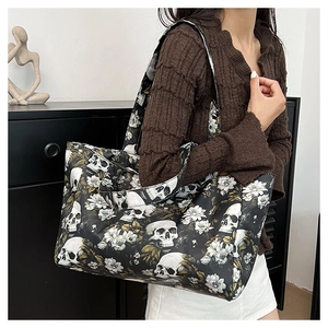 Detailed view of large tote bag featuring gothic skull and white floral prints