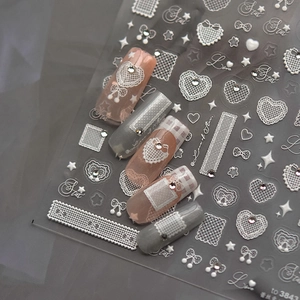 Lace heart nail art stickers with 3D relief and rhinestone accents for elegant manicures