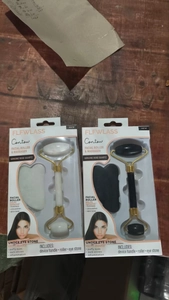 Dual-head facial rollers and gua sha sets in white and black with elegant gold accents