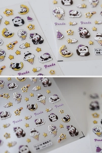 Macro view of 3D embossed panda nail stickers featuring cartoon designs and star elements