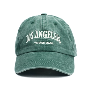 Vintage washed dark green baseball cap with Los Angeles embroidery on white background