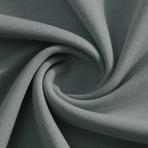 Macro shot of grey breathable mesh fabric texture and knit craftsmanship on polo shirt