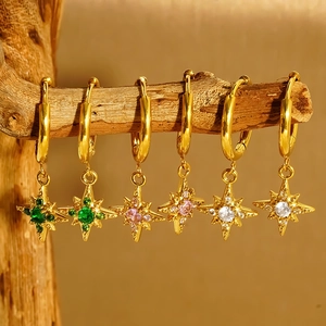 Gold 18K plated stainless steel star earrings with colorful gemstones on a wooden branch