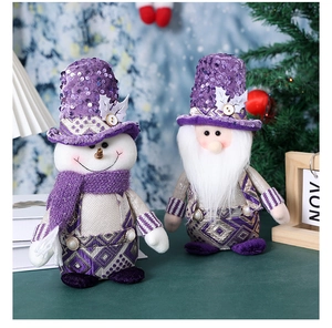 Detailed view of purple sequin Santa gnome and snowman figures with silver geometric patterns
