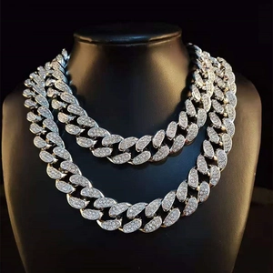 Macro shot of 20mm silver Cuban link chain with sparkling rhinestones in hip hop style