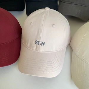 Detail of SUN letter embroidery on multi-colored cotton canvas baseball caps