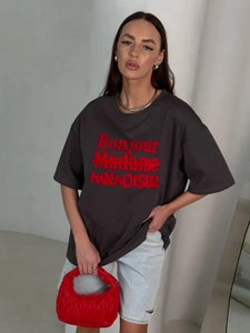 Detail of dark grey cotton T-shirt featuring red Bonjour Madame artistic lettering print