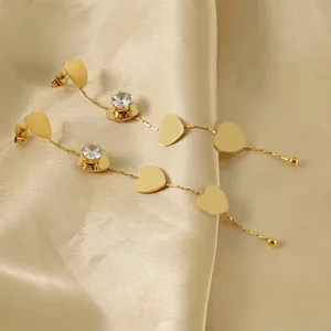 Elegant 18K gold-plated long tassel heart earrings with zircon studs on champagne silk