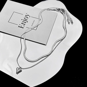 Detail of silver double-layer necklace with heart pendant, snake chain and lobster clasp