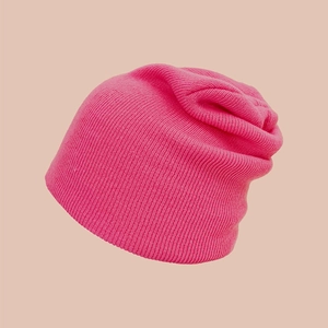 Detailed close-up showing the vertical ribbed knit texture of this rose pink winter beanie