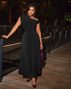 Detail of elegant black one-shoulder evening gown with waist pleats on wooden deck