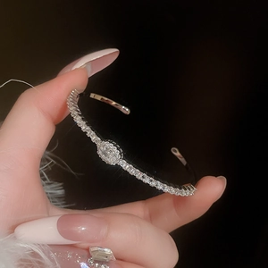 Macro shot of silver plated open bracelet with sparkling oval zircon stones detail