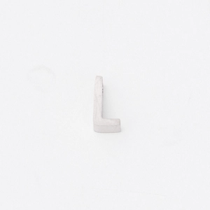 Macro shot of silver mirror-polished titanium steel letter L pendant with a small hole