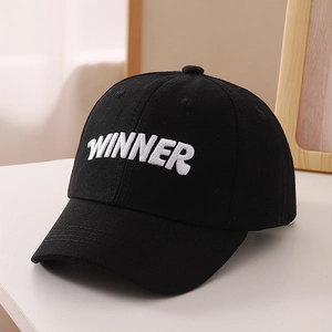 Close-up of WINNER 3D white embroidery on a premium black cotton kids baseball cap