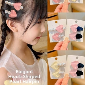 Detail of heart resin hair clips with white pearls and alloy pins for young girls