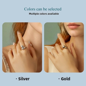 Detailed close-up showing adjustable teardrop open rings in silver and gold finishes
