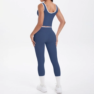 Detail view of navy yoga set with contrast white trim on high-waisted leggings and top