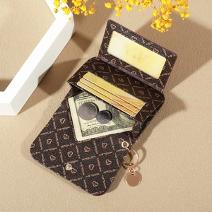 Detail view of brown printed card holder with multi-card slots and a metal keychain