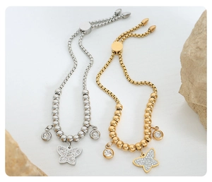 Close-up of gold and silver beaded butterfly pendant bracelets with adjustable clasp