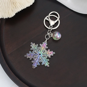 Detail of colorful acrylic snowflake keychain with iridescent bubble ball and metal clip