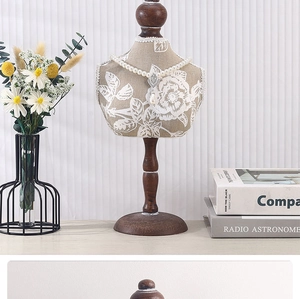 Detail of floral fabric bust necklace stand with solid wood base for jewelry display