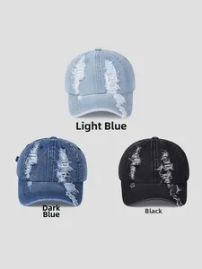 Three distressed denim baseball caps in light blue, dark blue, and black with ripped details
