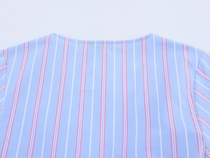 Close-up of the round neckline on a light blue striped casual shirt with sharp stitching