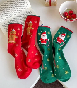 Detail view of festive Christmas socks featuring Santa Claus and gingerbread patterns