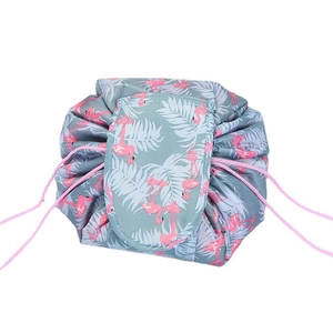 Portable drawstring makeup bag with pink flamingo and tropical palm leaf print