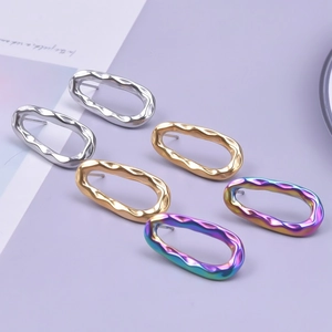 Detailed view of oval hammered 304 stainless steel earrings in silver, gold and rainbow