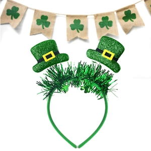 Detail of St. Patrick's Day headband with green sequin hats and shiny foil tinsel décor