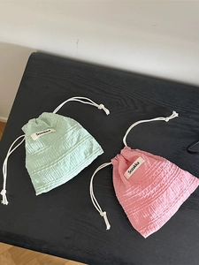 Cute drawstring organizer pouches in mint green and pink with textured grid fabric