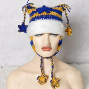 Detail of blue and yellow striped knit hat with cat ears and white faux fur trim stars