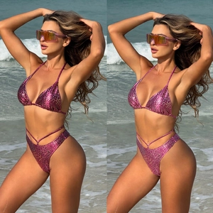 Detail of pink leopard print bikini fabric with drawstring ties and metallic finish