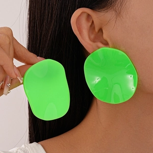 Neon green resin geometric oval stud earrings for women shown on model for size scaling