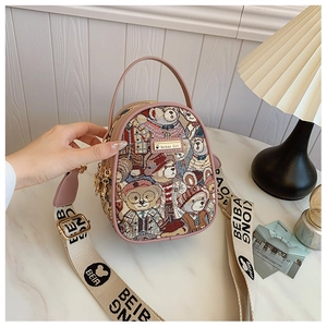 Detail of a teddy bear print mini bag with pink leather trim and Beibao logo strap