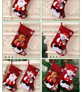 Close-up of festive Christmas stockings with Santa and snowman 3D plush appliques