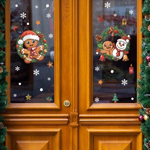 Christmas gingerbread man and snowman static window stickers on a glass wooden door